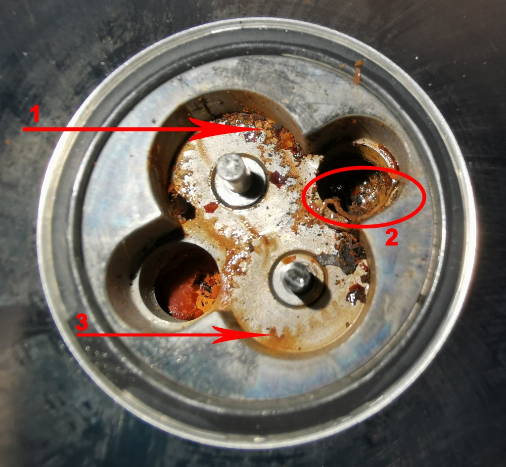 Механические загрязнения, ржавчина и остатки высохшей жидкости в измерительной камере расходомера.